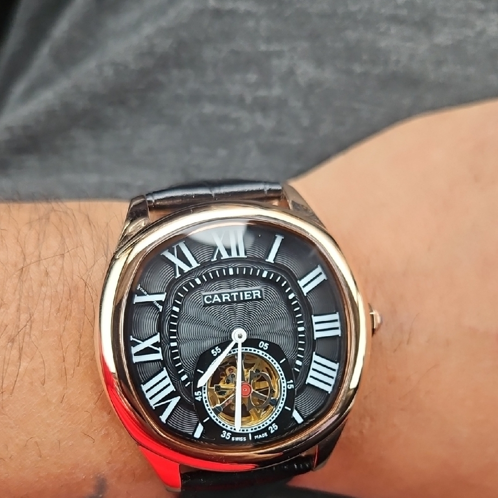 Cartier Black and Gold Timepiece with Roman Numerals